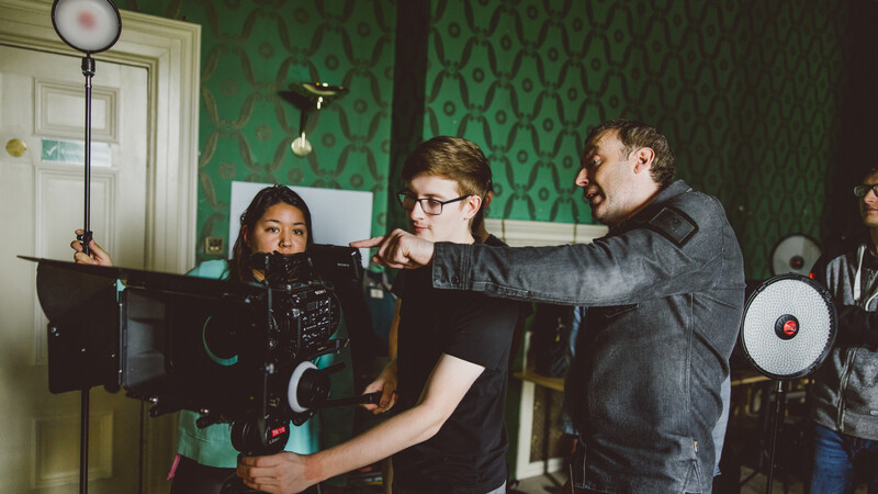 Students discussing camera work with Professor Students discussing camera work with Professor
