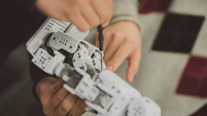 Student building a robot