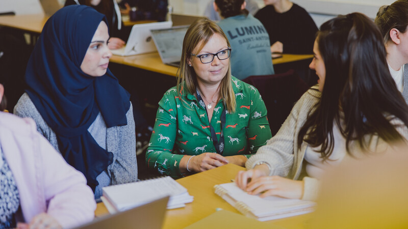 Tutor and teaching student discussing pedagogical approaches for teaching